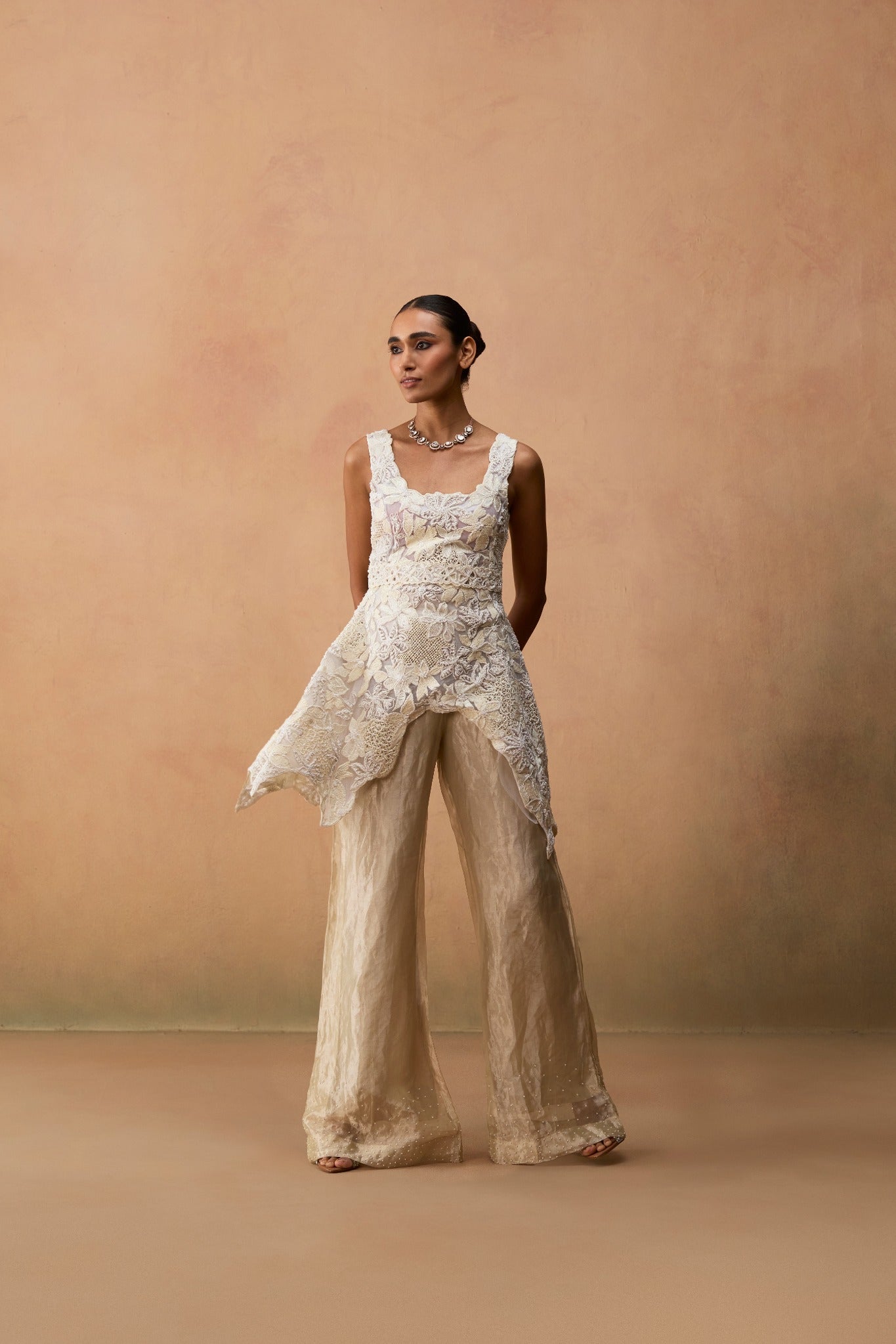 Rayana – ivory floral textured silver tissue high-low kurta with tissue bell bottom and belt by Julie & Rinki